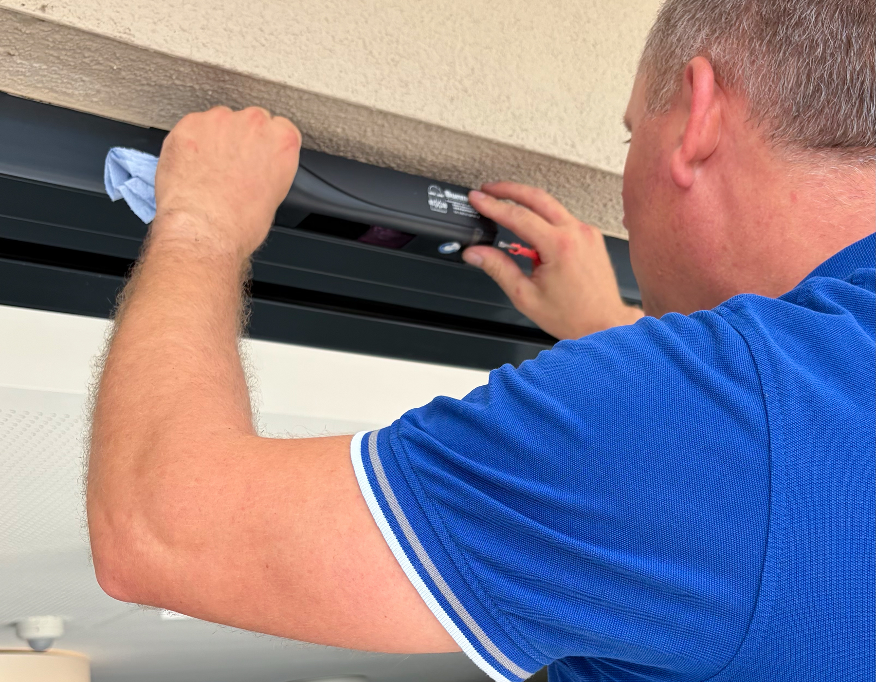 Servicetechniker bei der Wartung einer automatischen Türanlage